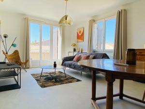 a living room with a couch and a table at Appartements Cabiscol in Beaucaire