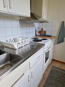 a kitchen with a sink and a stove at Nära centrum in Gothenburg