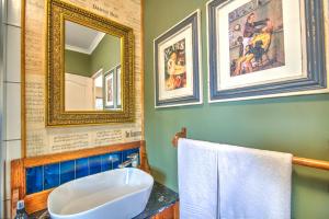 a bathroom with a sink and a mirror at Red Door Cottage in Wilderness +13 photos