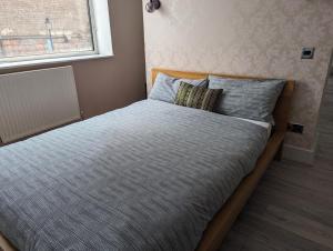 a bed with two pillows on it in a bedroom at Flat In Camden Town in London