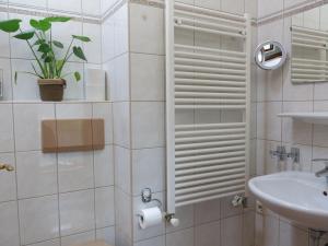 a bathroom with a shower with a toilet and a sink at Gästehaus Judith in Längenfeld