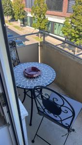a table on a balcony with a plate on it at LUX Business Apartments in Weil am Rhein