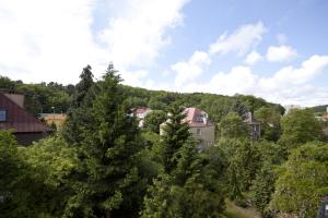 a group of houses on a hill with trees at Horizon Forest moj-sopot pl in Sopot