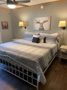 a bedroom with a large bed with blue and white pillows at Cozy 4br Lake Lanier GA Waterfront- Great Location in Gainesville