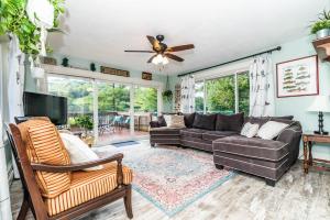 a living room with a couch and a tv at Chelsea Lake House, Game Room, & Pontoon-rental in Chelsea