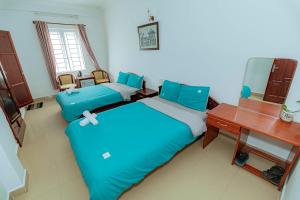 Postel nebo postele na pokoji v ubytování Pearl Wealth Dalat Hotel