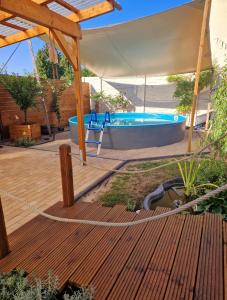 a wooden deck with a tub in a backyard at Ferienwohnung Sunny in Mittenwalde