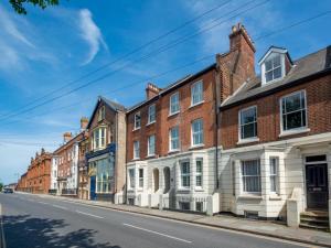 a row of brick houses on a street at Pass the Keys Luxury Townhouse In The City in Canterbury