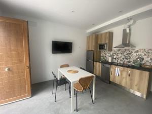 a kitchen with a table and chairs in a room at Apartamentos Santamira Street in Santillana del Mar +32 photos