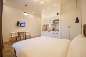 1 dormitorio con cama blanca y mesa en Self Check-in Apartments en Kiev