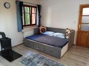 a bedroom with a bed in a room with a window at Garsonka u pivovaru, centrum Rožnov in Rožnov pod Radhoštěm