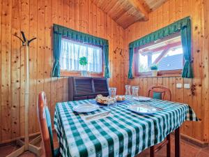 a dining room with a table in a cabin at Lepke Apartman in Harkány