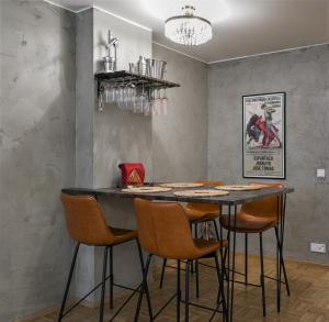a dining room with a table and chairs at Factory Loft with sauna in Turku