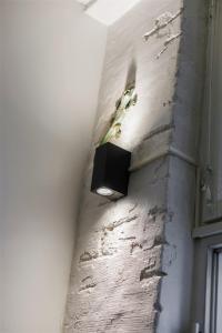 a light on the side of a wall at Loft in an old factory in Turku