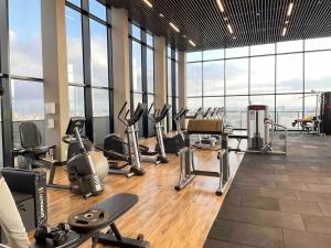a gym with a bunch of exercise equipment and windows at Bexp Spaces | VN Capote Valente in São Paulo