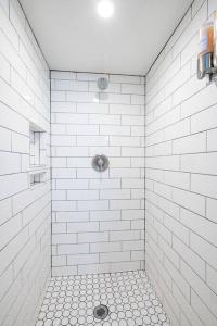 y baño con ducha de azulejos blancos y drenaje. en Hot Tub - Family Room - BBQ, en Salt Lake City 33 fotos más
