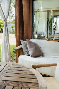 a living room with a couch and a table at The Bamboo House in Kailua-Kona