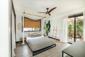 a bedroom with a bed and a large window at The Bamboo House in Kailua-Kona