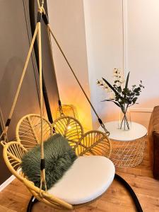 a swing chair with a green cushion in a room at SamaraS Place in Berlin