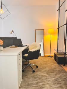an office with a desk with a chair and a laptop at SamaraS Place in Berlin