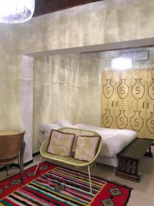 a bedroom with a bed and a table with two pillows at Dar Aron Tozeur in Tozeur