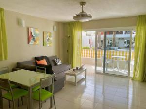 a living room with a couch and a table at TAGARA - 2 pools, ocean view, Puerto de Santiago in Puerto de Santiago