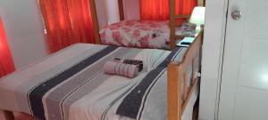 A bed or beds in a room at Hotel Quilla Wasi
