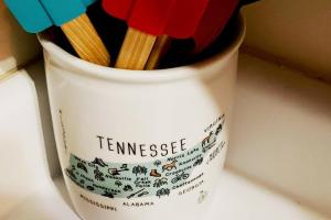 a cup with pencils in it sitting on a counter at Four Private Suites - Hot Tub - Arcade - Fast Wi-Fi - One Minute To Parkway Fun in Pigeon Forge