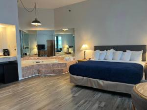 a hotel room with a bed and a bath tub at Riveredge Resort Hotel in Alexandria Bay