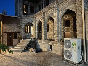 a large brick building with a cpu in front of it at Dervish Hostel in Bukhara