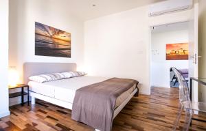 a bedroom with a bed and a painting on the wall at Casa Parco del Mare in Rimini +36 photos