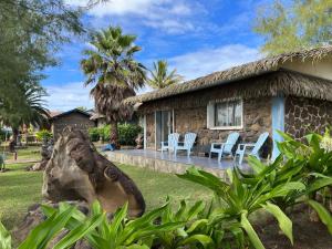 a stone house with a thatch roof at Hotel Boutique La Perouse in Hanga Roa