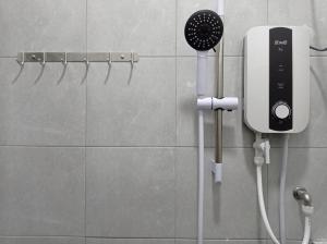 a hair dryer on a wall in a bathroom at E1397 Guest House in Kuantan