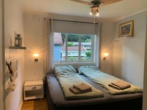 a bed in a room with a window at Sentral tomannsbolig ved park, Rjukan in Rjukan