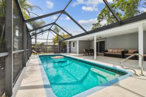 an indoor swimming pool in a house with a patio at Heated Pool! Paradise in Midtown Tampa 3B2B in Tampa
