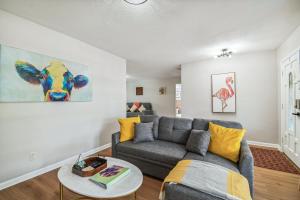 a living room with a couch and a table at Heated Pool! Paradise in Midtown Tampa 3B2B in Tampa +47 photos