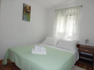 Postel nebo postele na pokoji v ubytování Apartments Nedjeljka