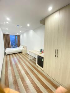 Zimmer mit einem Bett und einem Schreibtisch in einem Zimmer in der Unterkunft GOODTECH LUXURY Hotel & Apartment in Đà Nẵng
