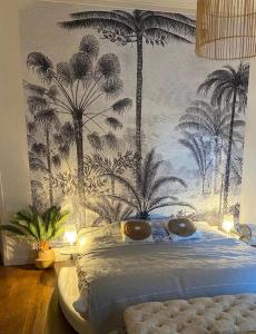 a bedroom with a bed with a mural of palm trees at Maison spacieuse avec spa, Niort in Niort