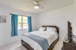 a bedroom with a bed and a ceiling fan at Port St Lucie Vacation Rental 9 Mi to Beach in Port Saint Lucie