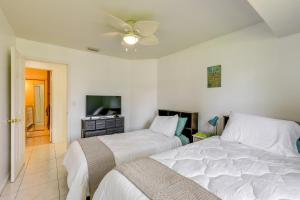 a bedroom with two beds and a flat screen tv at Port St Lucie Vacation Rental 9 Mi to Beach in Port Saint Lucie