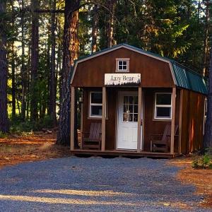 a tiny house in the middle of a forest at Lazy Bear Cabin 6 - Sleeps Up To 4 
