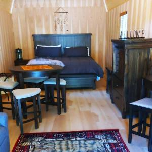 a bedroom with a bed and a table and chairs at Lazy Bear Cabin 6 - Sleeps Up To 4 