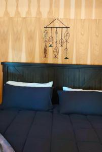 a bed with a wooden head board with two pillows at Lazy Bear Cabin 6 - Sleeps Up To 4 