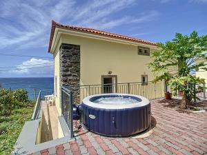a large hot tub in front of a house at My School I by Atlantic Holiday in Ponta Delgada