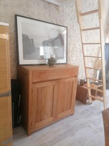 einen Fernseher auf einem Holzschrank in einem Zimmer in der Unterkunft Studio 2 à 4 personnes in Dompierre-sur-Mer