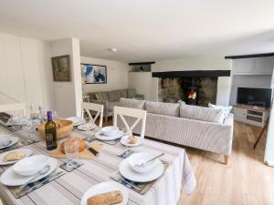 a living room with a table and a couch at Dairy Cottage in Weymouth