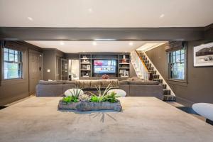a living room with a large table and a couch at Exquisite Bedford Lux Retreat. in Bedford