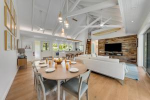 a dining room and living room with a table and chairs at Ka Hale Olu at Anini Beach TVNC#4218 in Kilauea