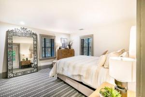 a bedroom with a large mirror and a bed at Exquisite Bedford Lux Retreat. in Bedford